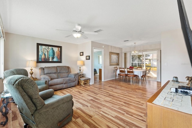 17890 SE 96th Ct, Summerfield, FL 34491 - living area featuring light wood-type flooring, a textured ceiling, a chandelier, and ceiling fan