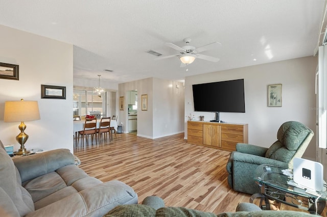 17890 SE 96th Ct, Summerfield, FL 34491 - living area featuring light wood-type flooring, a ceiling fan, and baseboards