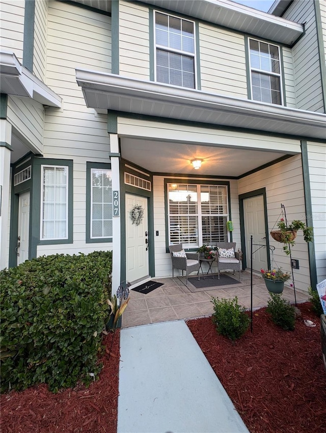 231 NE 28th Ave Unit 207, Ocala, FL 34470 - view of exterior entry featuring a porch and outdoor lounge area