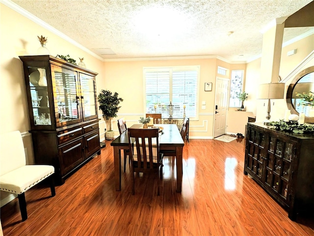 231 NE 28th Ave Unit 207, Ocala, FL 34470 - dining space featuring wood finished floors, a textured ceiling, and crown molding