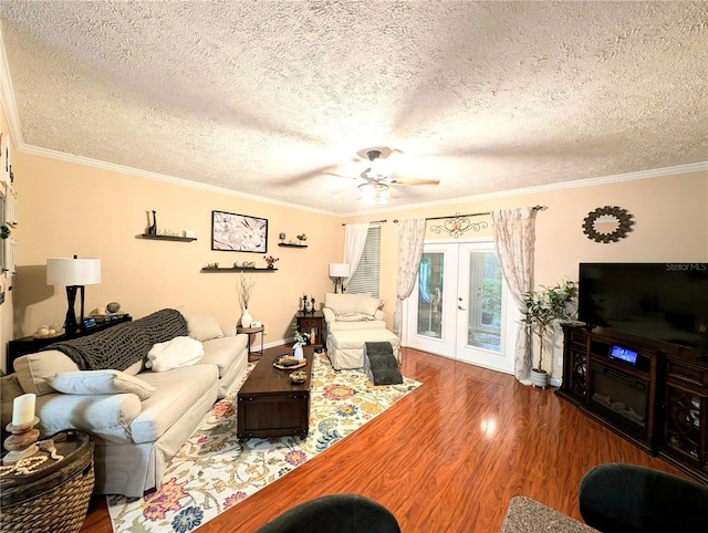 231 NE 28th Ave Unit 207, Ocala, FL 34470 - living room featuring wood finished floors, a textured ceiling, ornamental molding, french doors, and ceiling fan