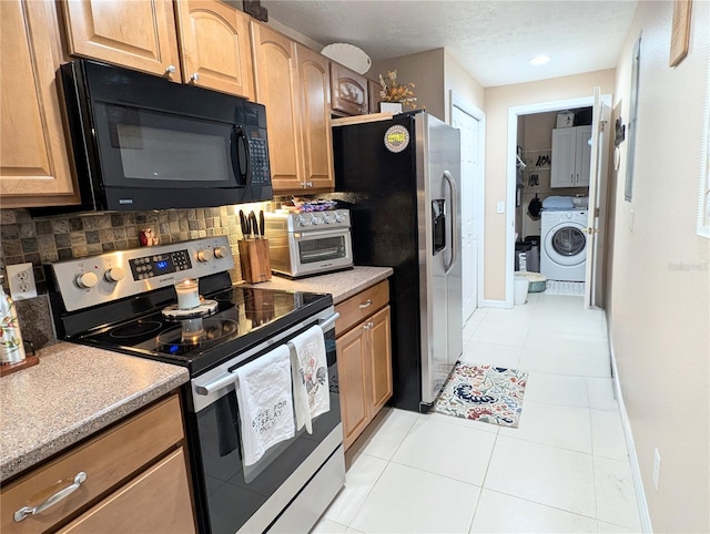 231 NE 28th Ave Unit 207, Ocala, FL 34470 - kitchen with appliances with stainless steel finishes, washer / dryer, backsplash, light tile patterned floors, and light countertops
