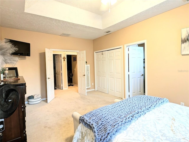 231 NE 28th Ave Unit 207, Ocala, FL 34470 - bedroom featuring light carpet, baseboards, and a textured ceiling