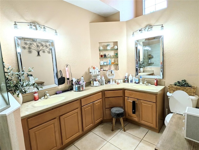231 NE 28th Ave Unit 207, Ocala, FL 34470 - bathroom with tile patterned floors, toilet, double vanity, and a textured wall