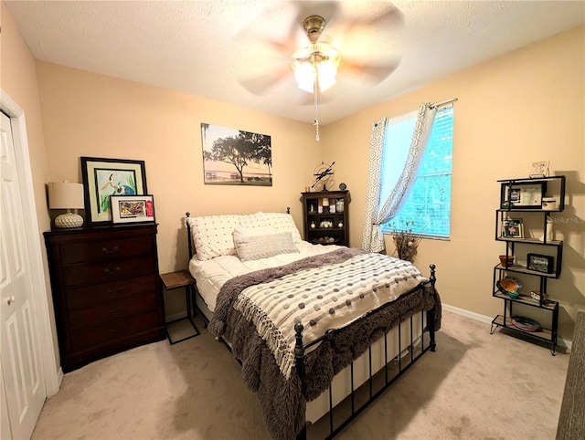 231 NE 28th Ave Unit 207, Ocala, FL 34470 - bedroom featuring light carpet, baseboards, and ceiling fan