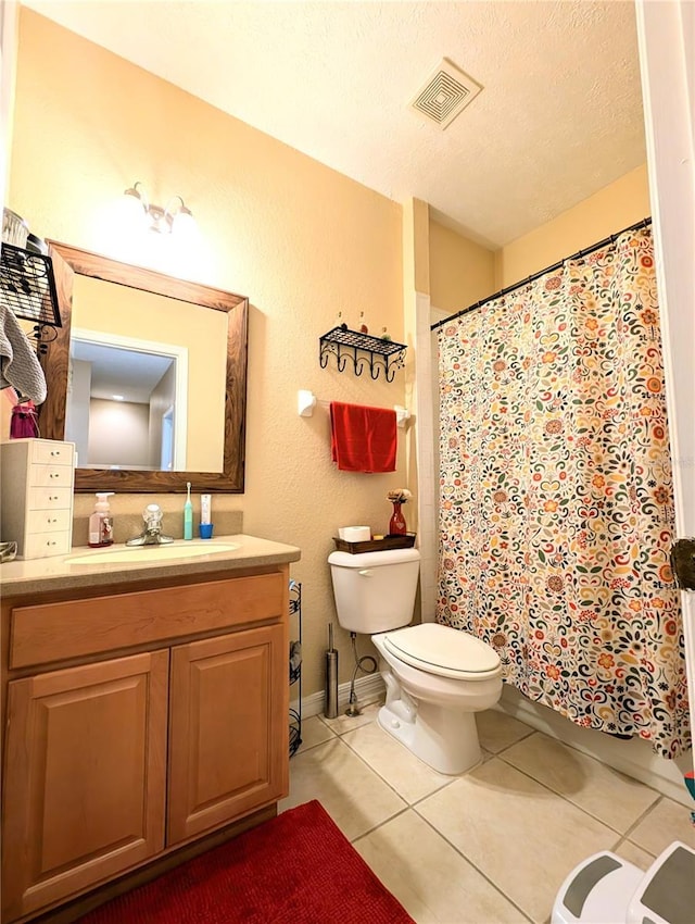 231 NE 28th Ave Unit 207, Ocala, FL 34470 - bathroom featuring toilet, tile patterned flooring, vanity, a textured ceiling, and curtained shower