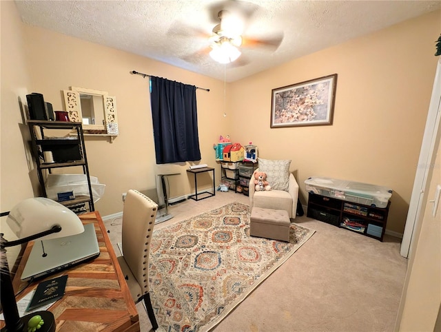 231 NE 28th Ave Unit 207, Ocala, FL 34470 - sitting room with carpet, ceiling fan, an office area, a textured ceiling, and baseboards