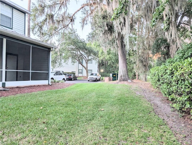 231 NE 28th Ave Unit 207, Ocala, FL 34470 - view of grassy yard featuring a sunroom