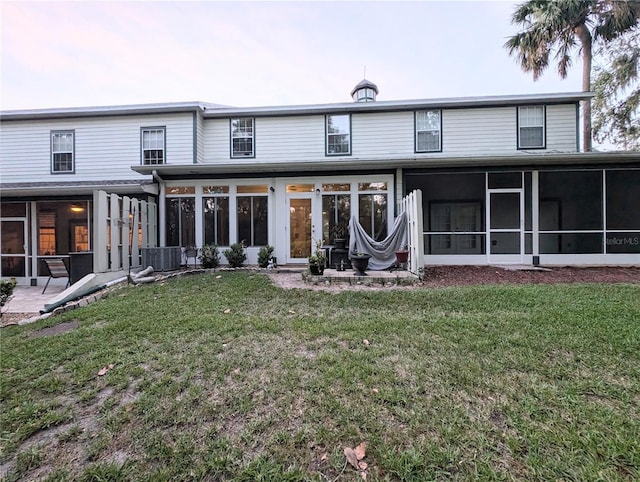 231 NE 28th Ave Unit 207, Ocala, FL 34470 - back of property with a sunroom, central AC unit, and a yard