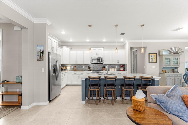 9203 SW 97th Cir, Ocala, FL 34481 - kitchen featuring stainless steel appliances, a breakfast bar, decorative backsplash, light countertops, and white cabinetry
