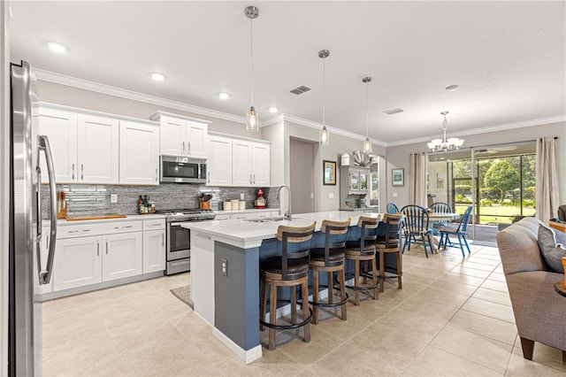 9203 SW 97th Cir, Ocala, FL 34481 - kitchen featuring stainless steel appliances, a sink, a chandelier, decorative backsplash, and ornamental molding