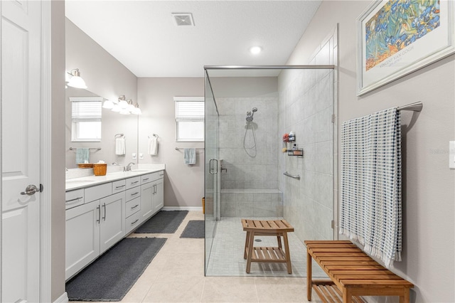 9203 SW 97th Cir, Ocala, FL 34481 - bathroom with double vanity, a stall shower, and tile patterned floors