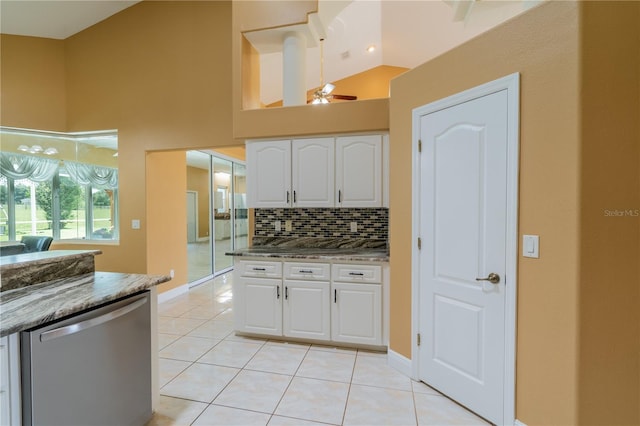 5815 NE 70th St, Silver Springs, FL 34488 - kitchen featuring stainless steel dishwasher, white cabinetry, light tile patterned flooring, decorative backsplash, and a ceiling fan