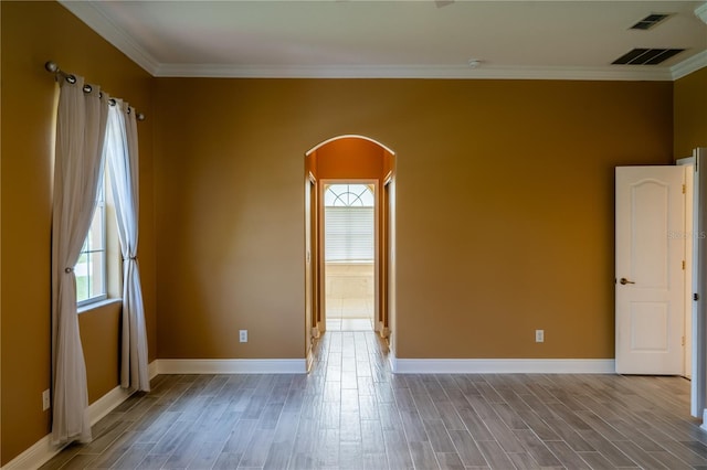 5815 NE 70th St, Silver Springs, FL 34488 - spare room with arched walkways, crown molding, wood finished floors, and baseboards