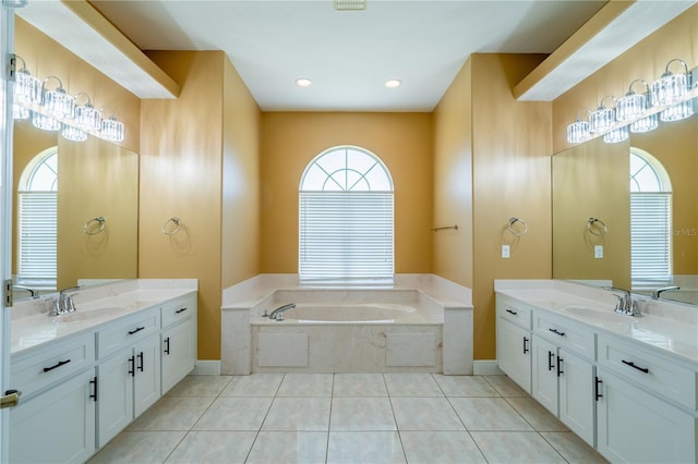 5815 NE 70th St, Silver Springs, FL 34488 - bathroom with a bath, two vanities, tile patterned floors, recessed lighting, and baseboards