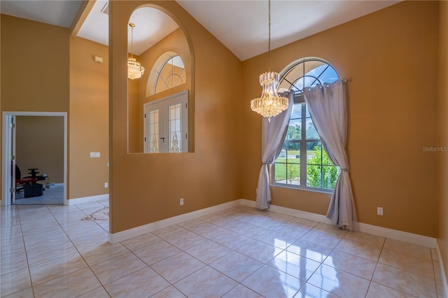 5815 NE 70th St, Silver Springs, FL 34488 - tiled empty room featuring a chandelier, high vaulted ceiling, and baseboards