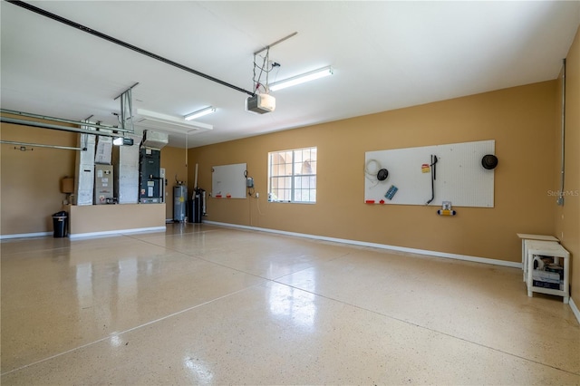 5815 NE 70th St, Silver Springs, FL 34488 - garage featuring a garage door opener, baseboards, water heater, and heating unit