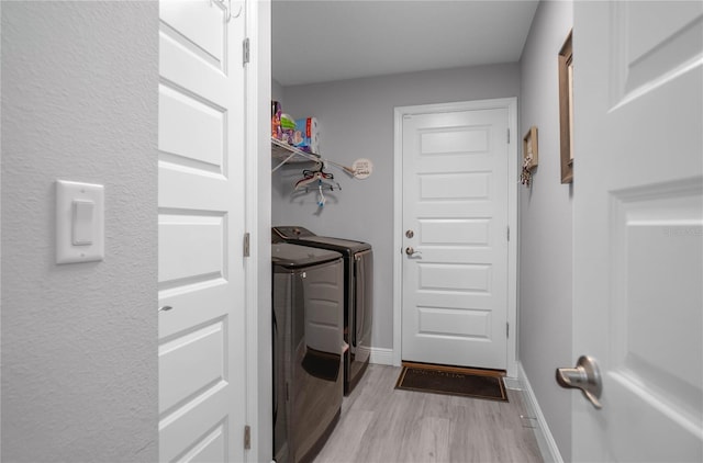 9805 N Dana Way, Citrus Springs, FL 34433 - laundry room with independent washer and dryer, light wood-style flooring, and baseboards