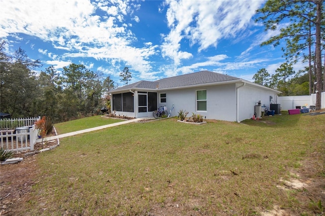 9805 N Dana Way, Citrus Springs, FL 34433 - rear view of house featuring a sunroom, stucco siding, and central AC