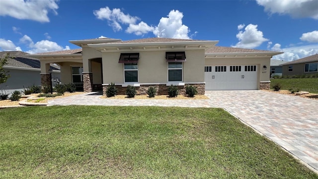 10287 SW 96th Ln, Ocala, FL 34481 - prairie-style home featuring stucco siding, an attached garage, decorative driveway, and a front lawn