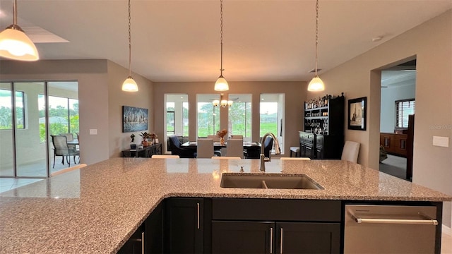 10287 SW 96th Ln, Ocala, FL 34481 - kitchen featuring a sink, open floor plan, light stone counters, and decorative light fixtures