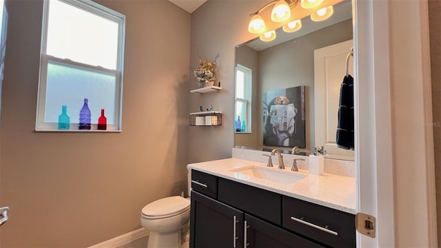 10287 SW 96th Ln, Ocala, FL 34481 - bathroom featuring vanity, plenty of natural light, toilet, and baseboards
