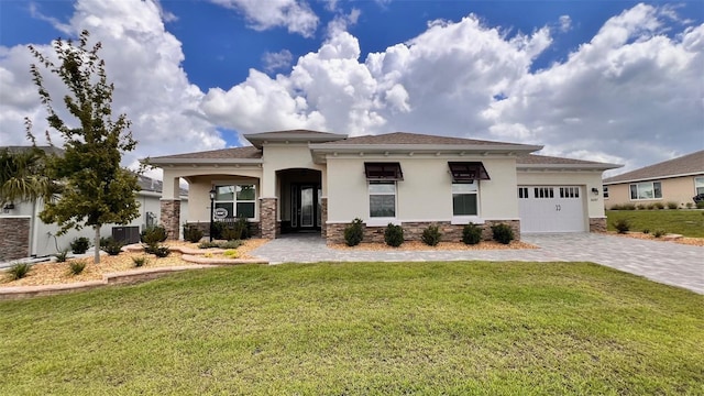 10287 SW 96th Ln, Ocala, FL 34481 - prairie-style home with stucco siding, decorative driveway, a garage, a front yard, and central AC unit