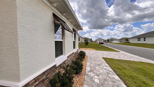 10287 SW 96th Ln, Ocala, FL 34481 - view of property exterior featuring stucco siding, a residential view, and a yard