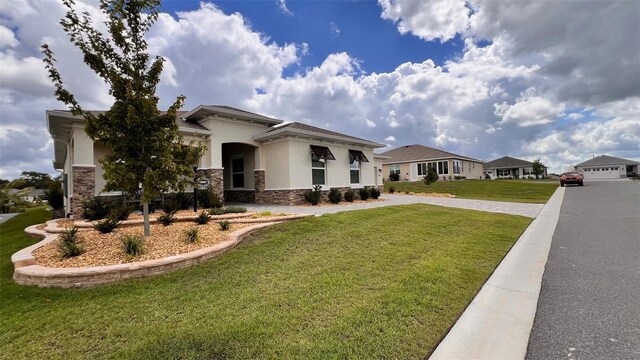 10287 SW 96th Ln, Ocala, FL 34481 - prairie-style home with stone siding, a front yard, and stucco siding