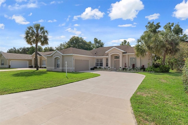4731 N Crestline Dr, Beverly Hills, FL 34465 - ranch-style house with an attached garage, concrete driveway, stucco siding, and a front lawn