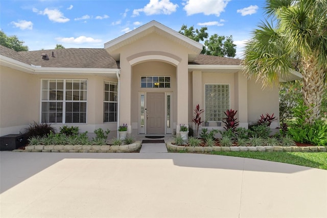 4731 N Crestline Dr, Beverly Hills, FL 34465 - entrance to property featuring stucco siding and a shingled roof