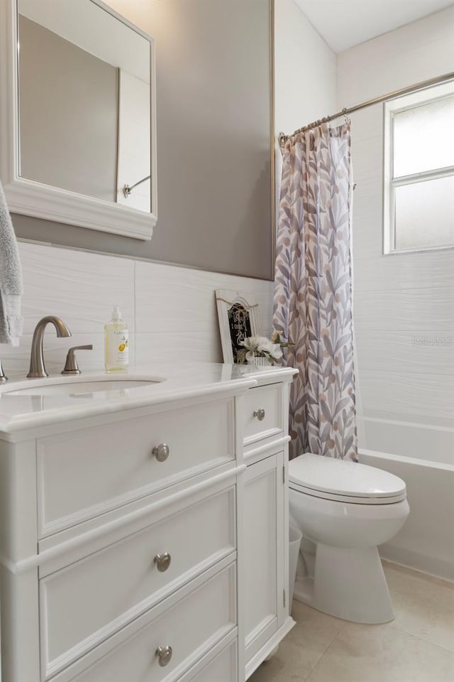4731 N Crestline Dr, Beverly Hills, FL 34465 - bathroom with vanity, shower / tub combo, tile patterned flooring, and a wainscoted wall