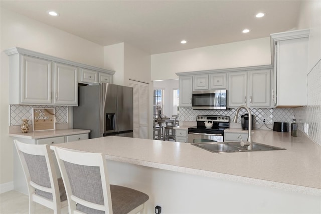 4731 N Crestline Dr, Beverly Hills, FL 34465 - kitchen featuring stainless steel appliances, a peninsula, decorative backsplash, light countertops, and recessed lighting