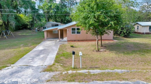 1322 NE 53rd St, Ocala, FL 34479 - view of front facade featuring a front lawn, an attached carport, and driveway
