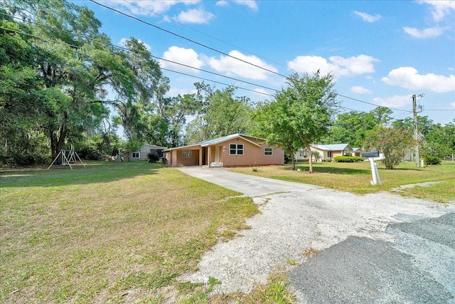 1322 NE 53rd St, Ocala, FL 34479 - view of front facade featuring concrete driveway, a front lawn, and an attached carport