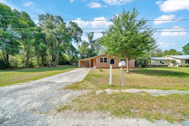 1322 NE 53rd St, Ocala, FL 34479 - single story home with driveway, a front lawn, and a carport