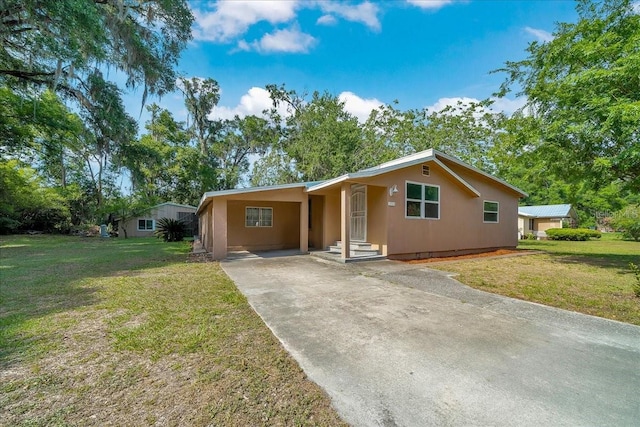 1322 NE 53rd St, Ocala, FL 34479 - view of front of property with concrete driveway, a front lawn, and a carport