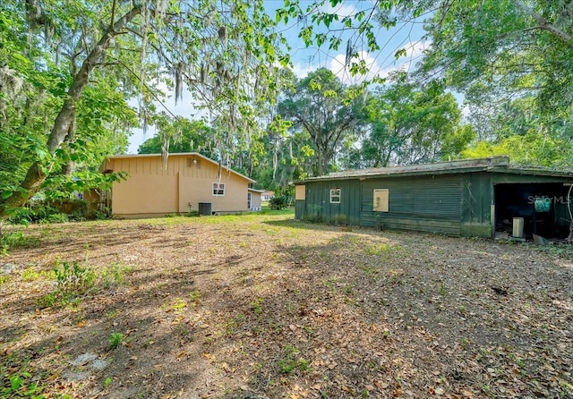 1322 NE 53rd St, Ocala, FL 34479 - view of yard featuring central AC unit and an outdoor structure