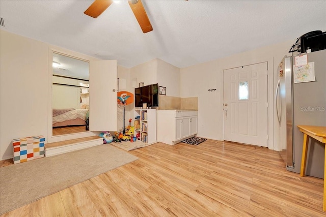 1322 NE 53rd St, Ocala, FL 34479 - foyer featuring light wood-type flooring, ceiling fan, and a textured ceiling
