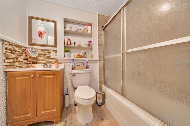 1322 NE 53rd St, Ocala, FL 34479 - full bathroom featuring wood finished floors, toilet, enclosed tub / shower combo, vanity, and built in shelves