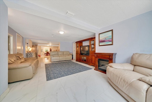 1322 NE 53rd St, Ocala, FL 34479 - living area featuring a glass covered fireplace and light marble finish floors