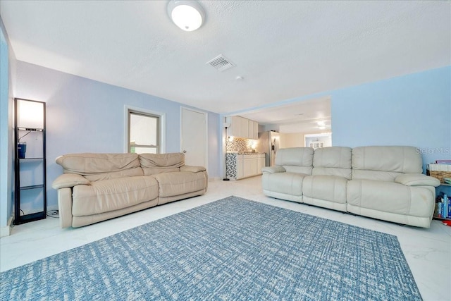 1322 NE 53rd St, Ocala, FL 34479 - living room with a textured ceiling and light marble finish flooring
