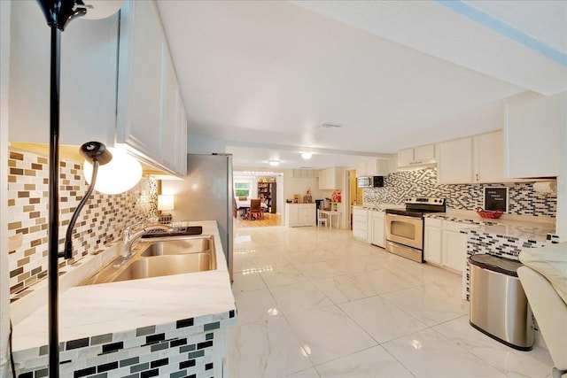 1322 NE 53rd St, Ocala, FL 34479 - kitchen with stainless steel electric range, tasteful backsplash, and light countertops