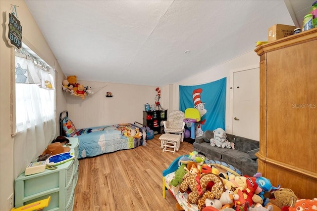 1322 NE 53rd St, Ocala, FL 34479 - bedroom featuring vaulted ceiling and wood finished floors
