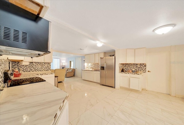 1322 NE 53rd St, Ocala, FL 34479 - kitchen featuring stainless steel refrigerator with ice dispenser, tasteful backsplash, electric stove, light marble finish flooring, and light stone countertops