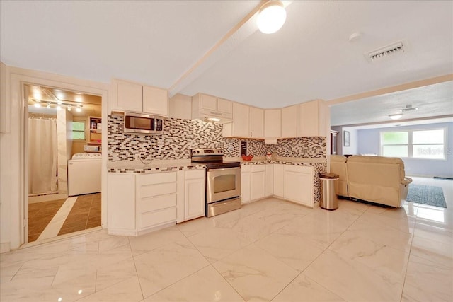 1322 NE 53rd St, Ocala, FL 34479 - kitchen with stainless steel appliances, washer / clothes dryer, light marble finish floors, decorative backsplash, and open floor plan