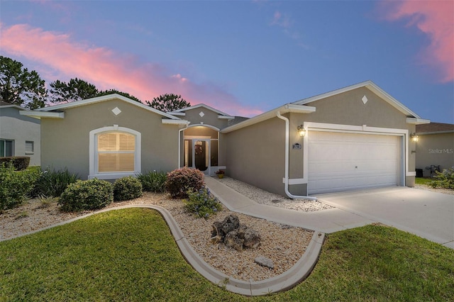 15119 SW 14th Avenue Rd, Ocala, FL 34473 - view of front of home featuring stucco siding, a garage, driveway, and a front yard