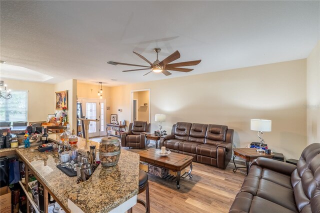 4015 SE 22nd St, Ocala, FL 34471 - living room with light wood-style floors, a ceiling fan, and a chandelier