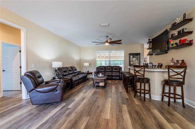 4015 SE 22nd St, Ocala, FL 34471 - living room with dark wood-style flooring, a dry bar, ceiling fan, and baseboards