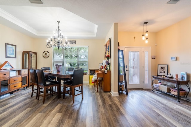 4015 SE 22nd St, Ocala, FL 34471 - dining space featuring a chandelier, dark wood-style flooring, a raised ceiling, ornamental molding, and baseboards